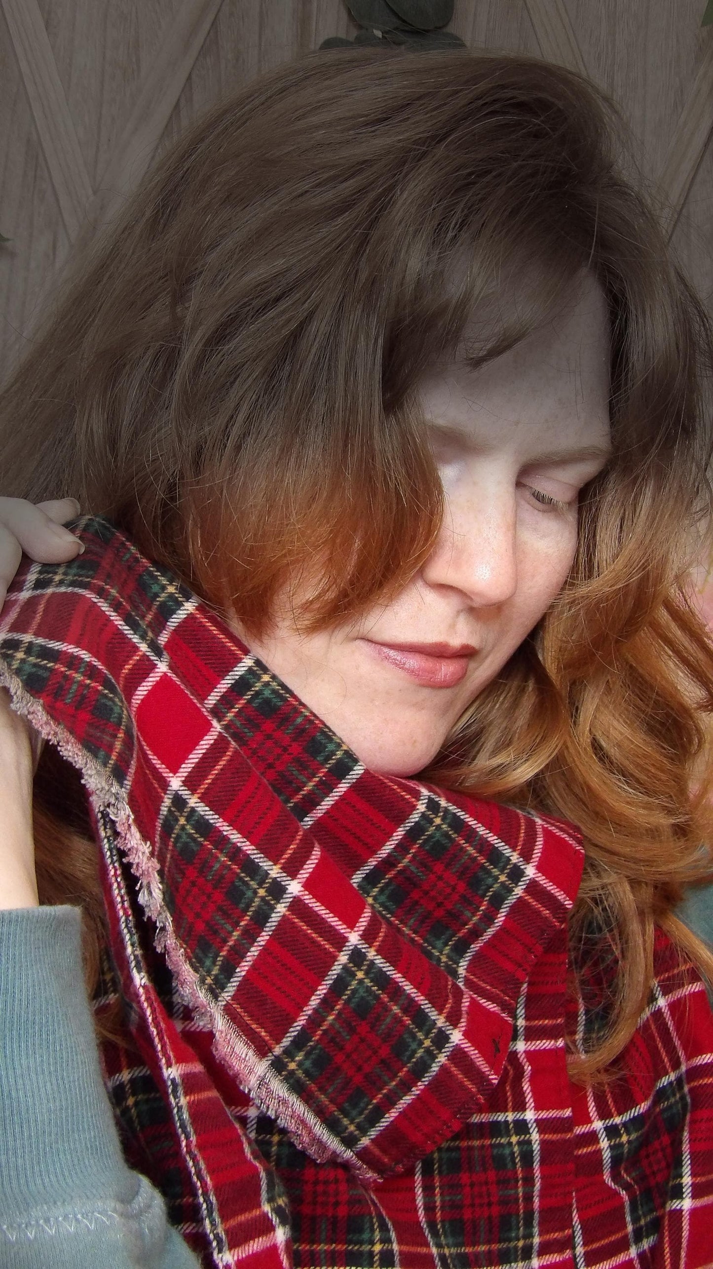 Model wearing red tartan flannel scarf made of 100% cotton. Soft, warm cotton fleece with a royal stewart inspired plaid design. Handmade in Washington State, USA