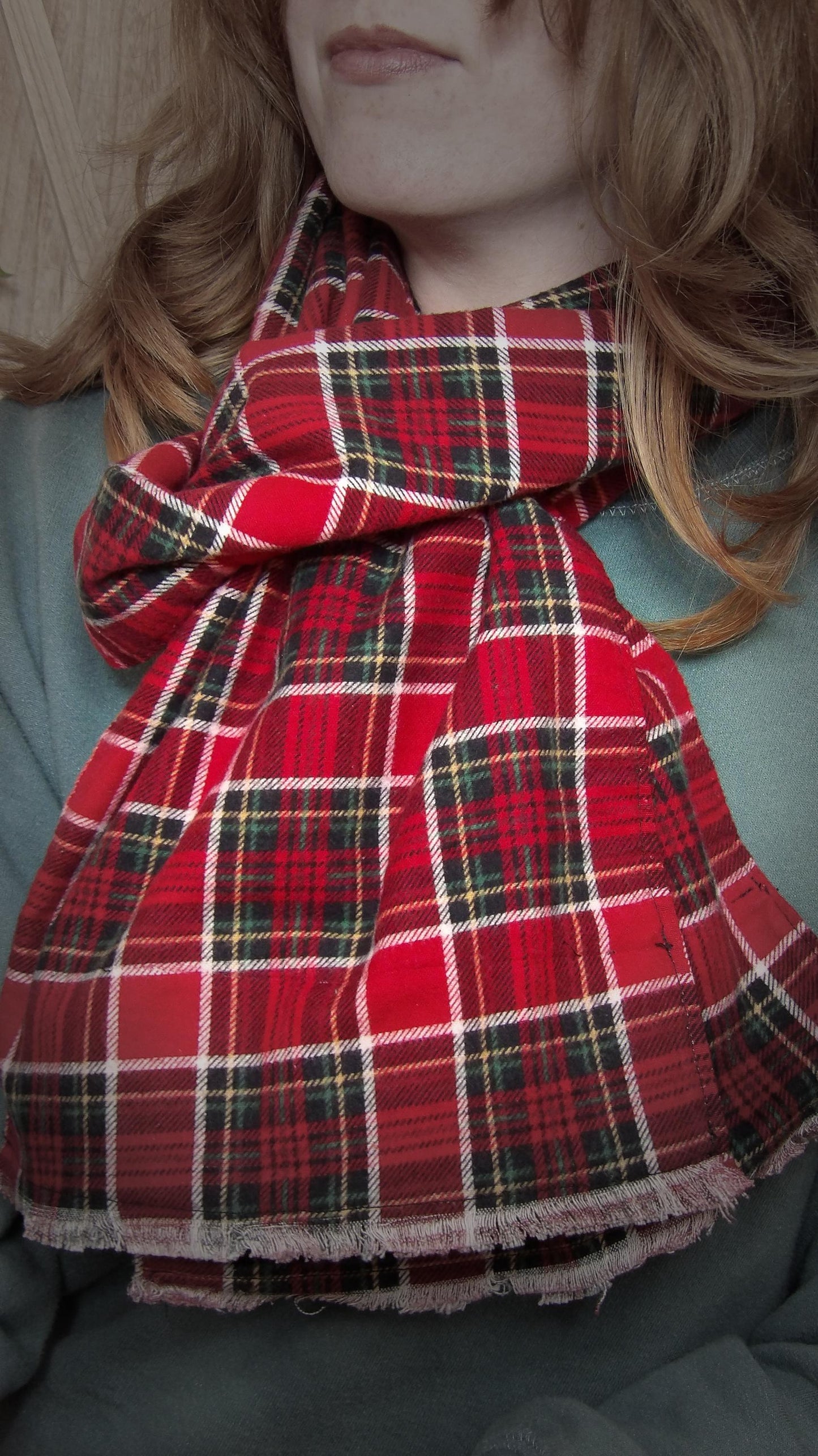 Model wearing red tartan flannel scarf made of 100% cotton. Soft, warm cotton fleece with a royal stewart inspired plaid design. Handmade in Washington State, USA