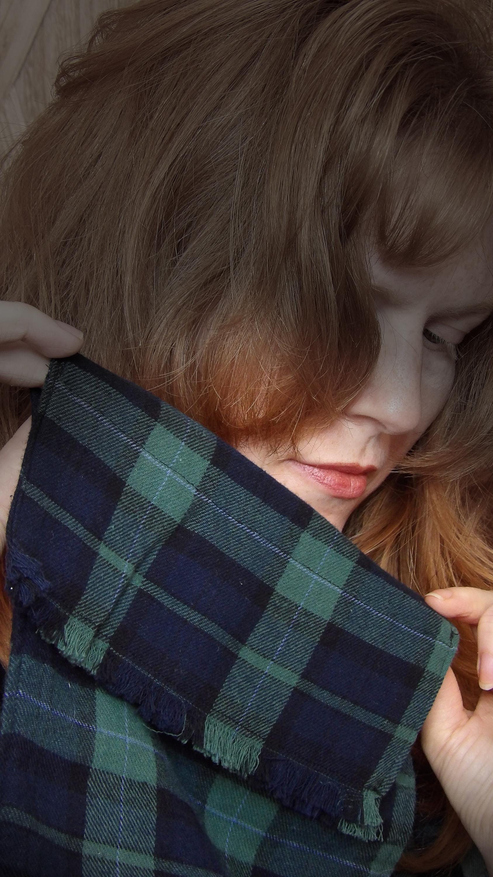 Model wearing black watch tartan flannel scarf made of 100% cotton. Soft, warm cotton fleece. Handmade in Washington State, USA