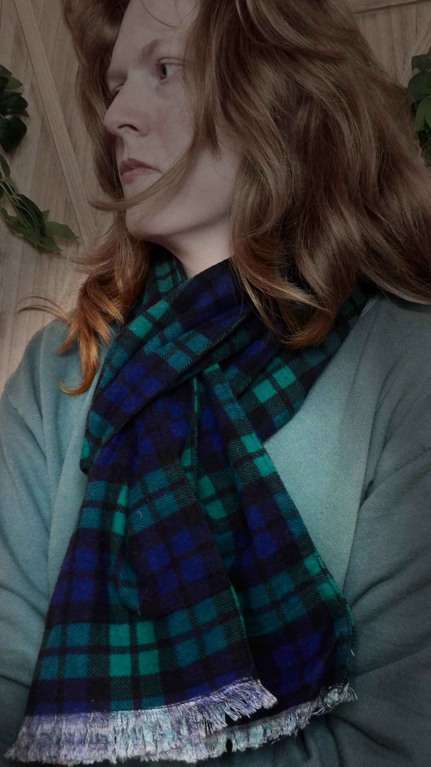 Model wearing black watch tartan flannel scarf made of 100% cotton. Soft, warm cotton fleece. Handmade in Washington State, USA