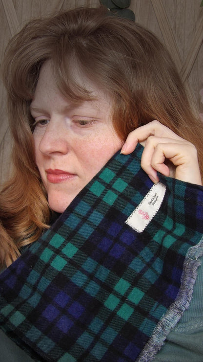 Model wearing black watch tartan flannel scarf made of 100% cotton. Soft, warm cotton fleece. Handmade in Washington State, USA