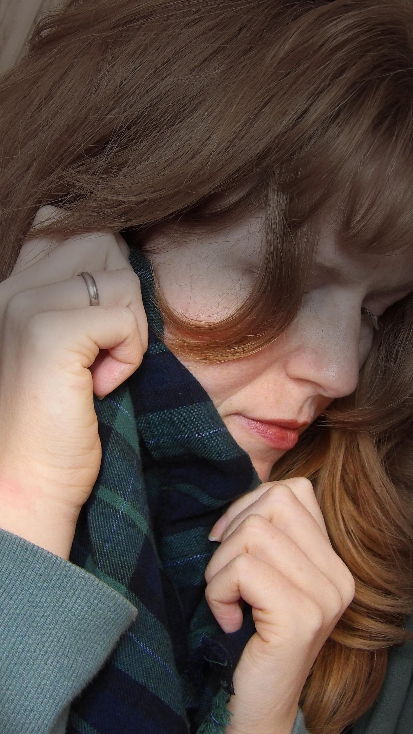 Model wearing black watch tartan flannel scarf made of 100% cotton. Soft, warm cotton fleece. Handmade in Washington State, USA