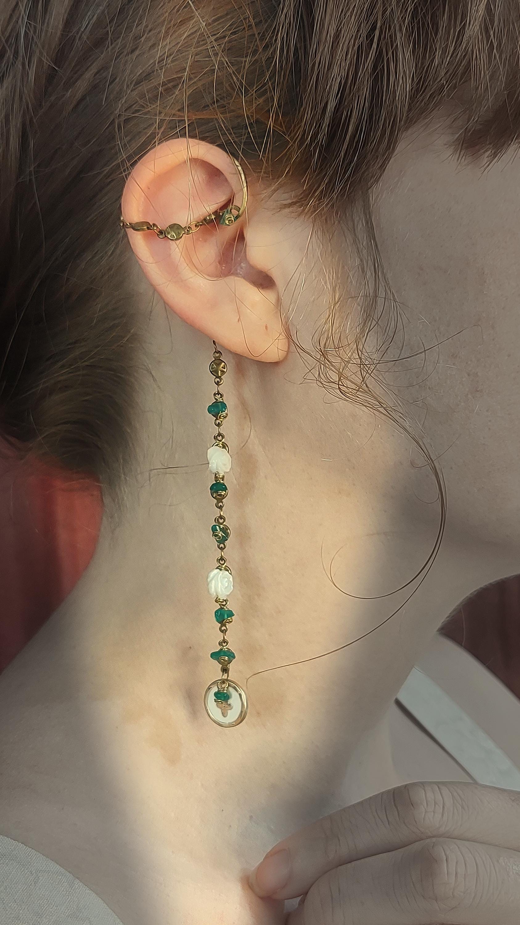 Rustic Ear Wrap With Green Onyx Chips, Mother Of pearl Roses and old world style cross coin on a brass star chain. Piercless ear cuff frame that rests behind the ear