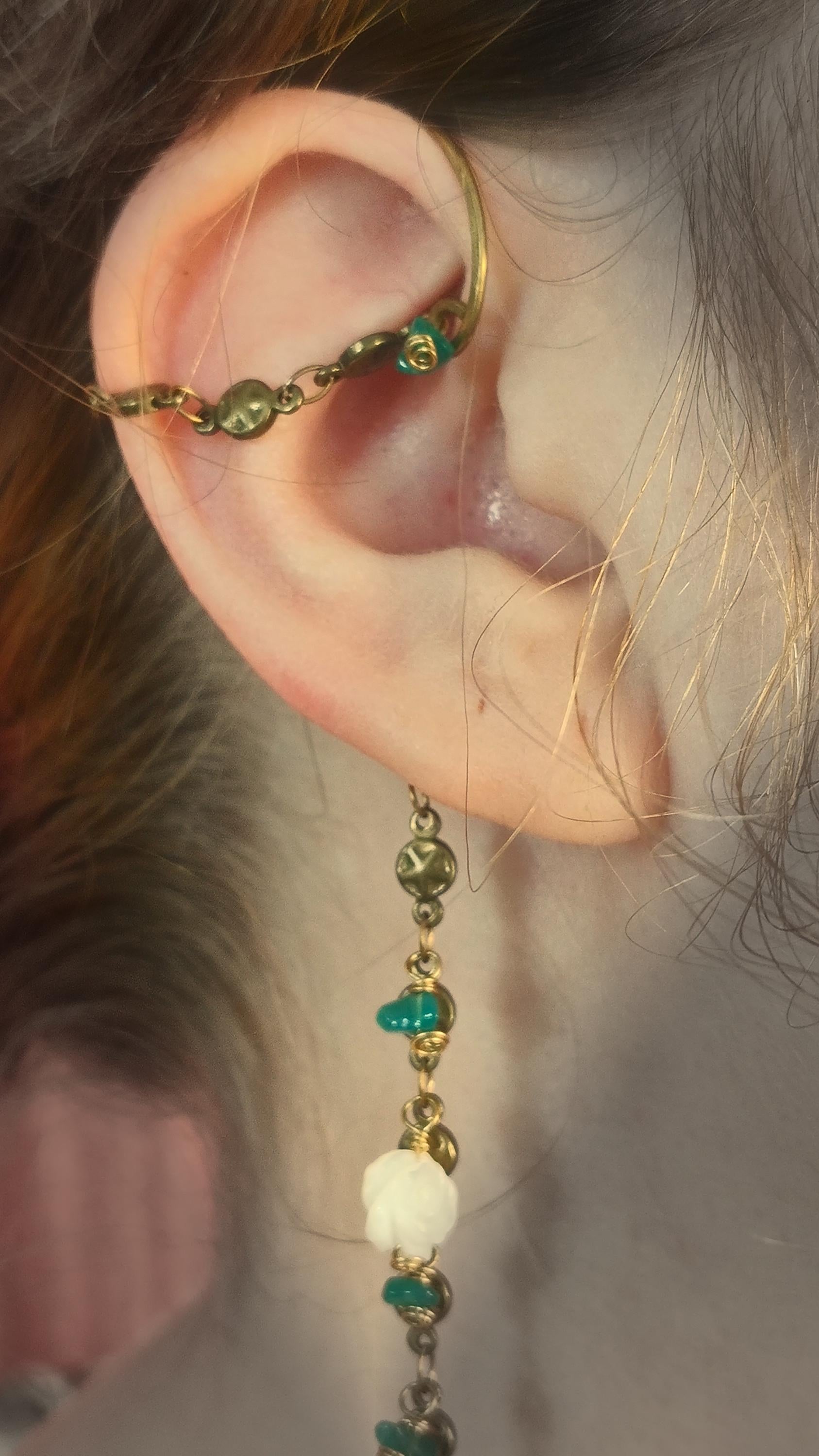 Rustic Ear Wrap With Green Onyx Chips, Mother Of pearl Roses and old world style cross coin on a brass star chain. Piercless ear cuff frame that rests behind the ear